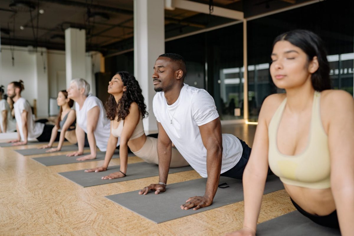 Diverse people doing yoga or art in a bright repurposed community space.jpg