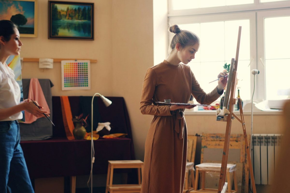 person painting with others in art therapy setting hopeful vibe.jpg