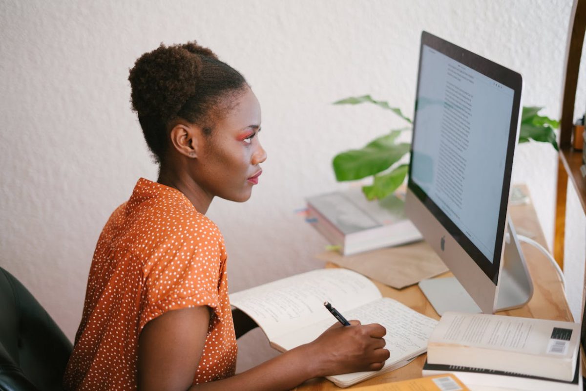 person using laptop creatively with AI tools, confident and empowered.jpg